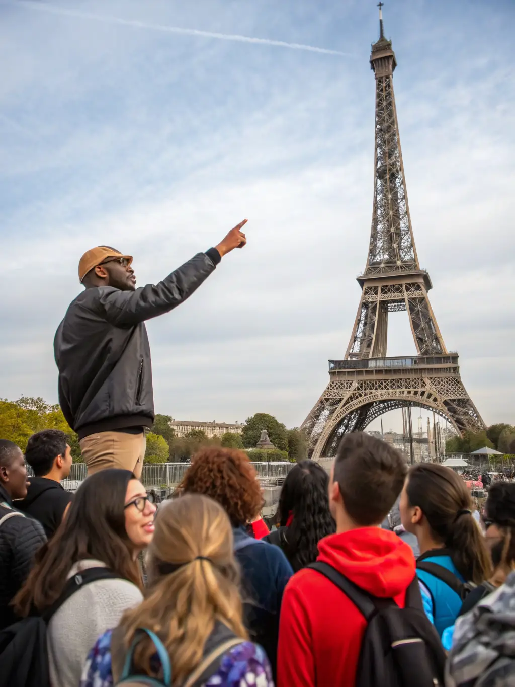 A photo of a guided tour group exploring a local historical landmark with a LES ALLUCHONS guide, emphasizing their role in providing public access to historical knowledge.